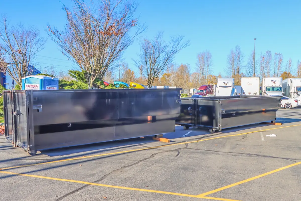 Professional dumpster rental service with roll-off container on residential driveway in Bucyrus